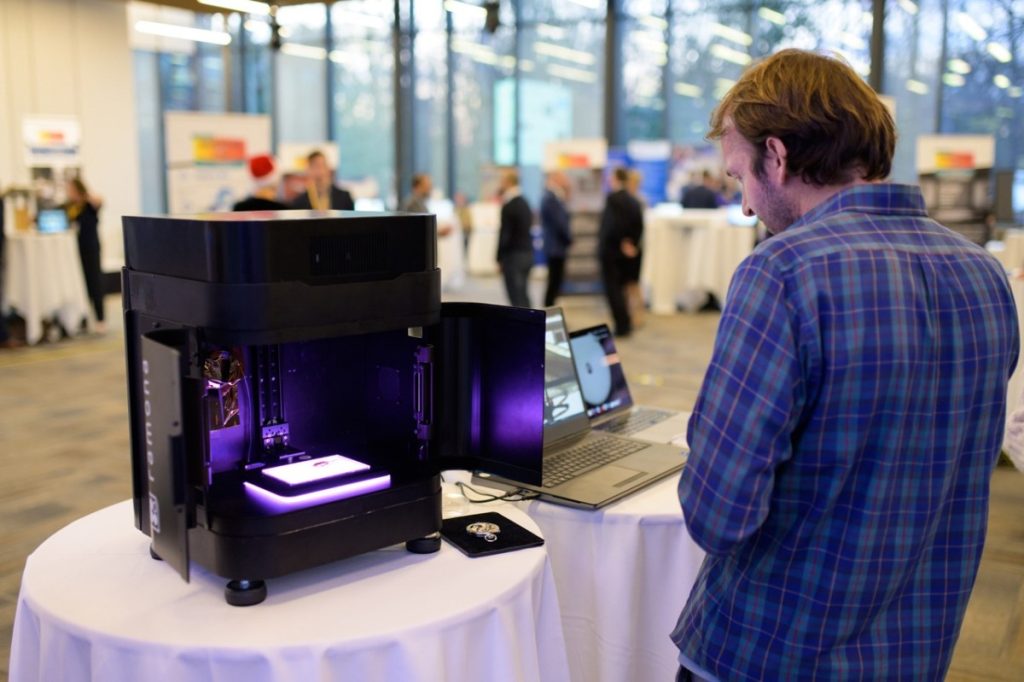 Roarke Horstmeyer sets up a Ramona Optics microscope for demonstration.