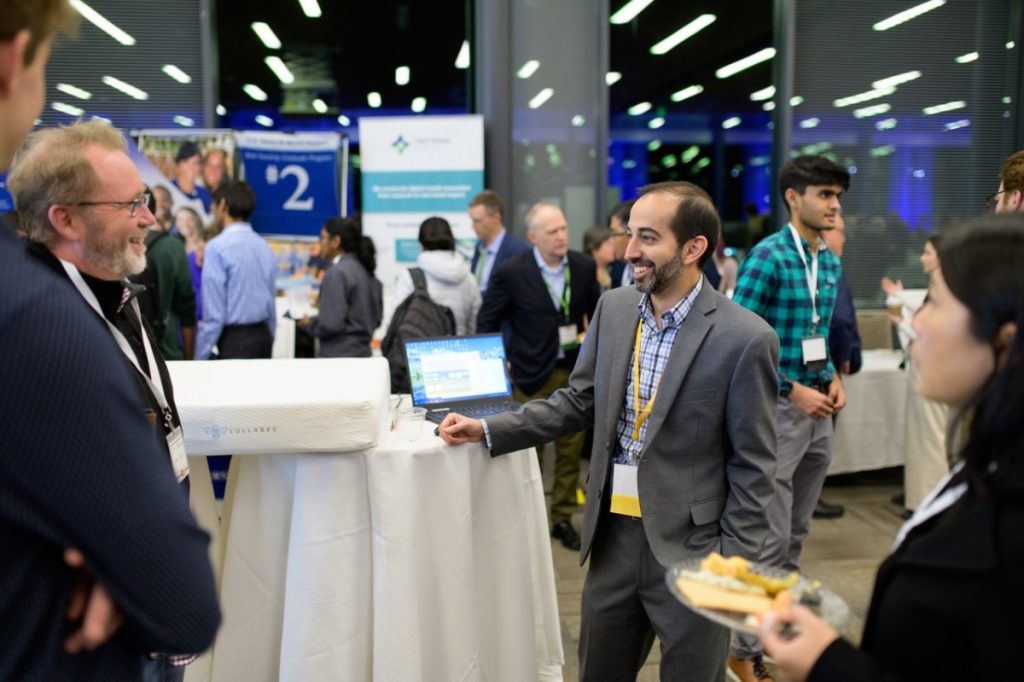 Sujay Kansagra, center, shows off the Lullabee mattress to attendees.