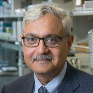 Ashutosh Chilkoti headshot with laboratory background.